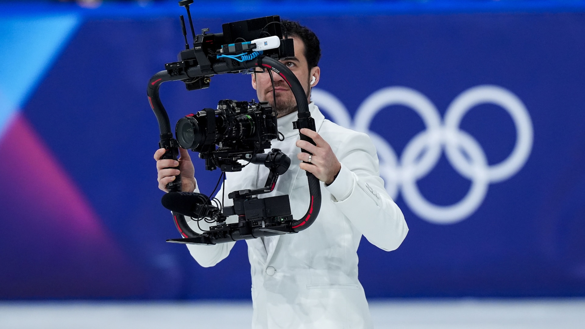 Jordan Cowan filming a figure skater on ice.