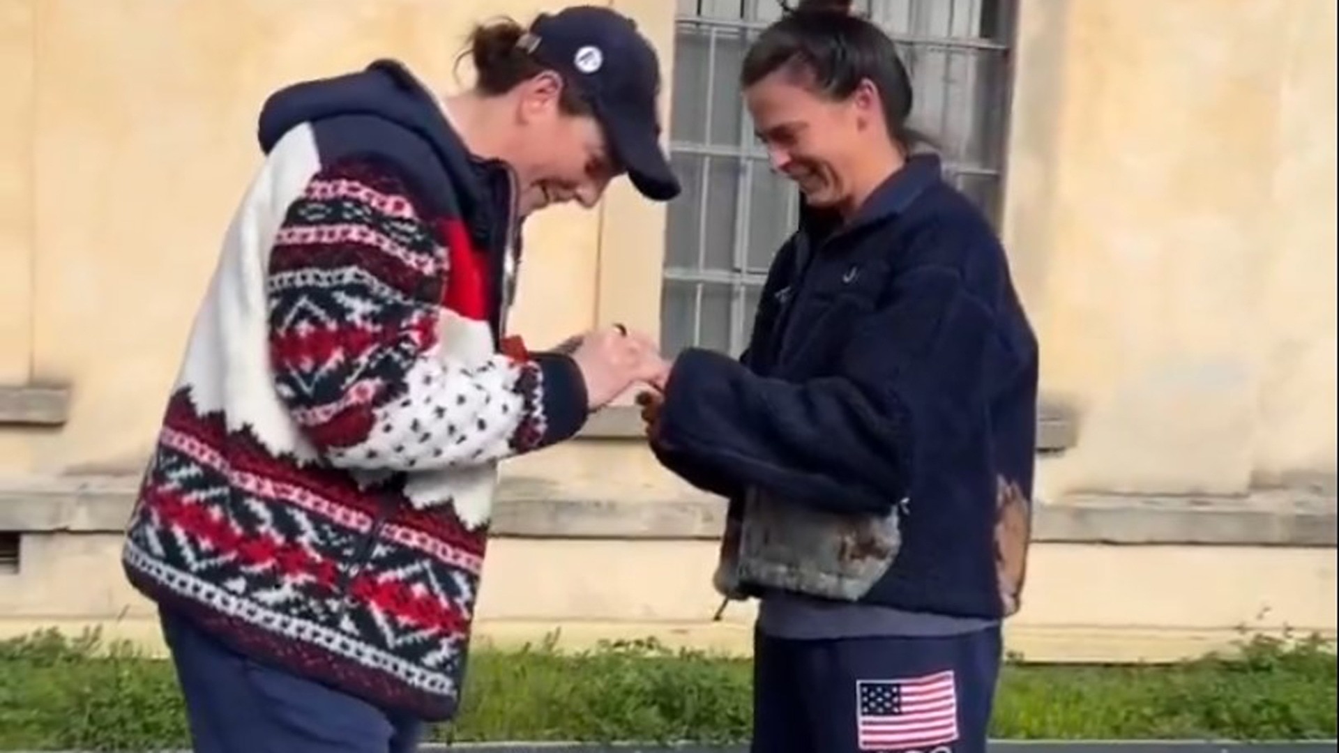 Olympic hockey player Hilary Knight puts an engagement ring on speed skater Brittany Bowe's finger.
