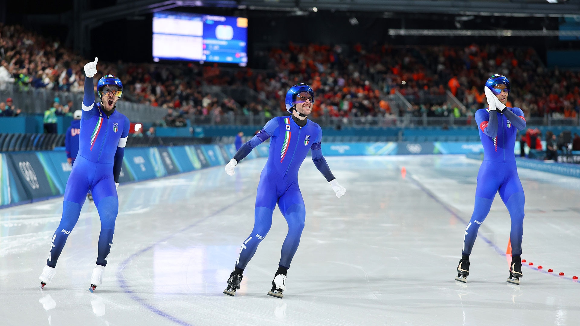 Davide Ghiotto, Michele Malfatti, and Andrea Giovannini celebrate after winning gold in men's team pursuit Feb. 17, 2026 in Milan, Italy.
