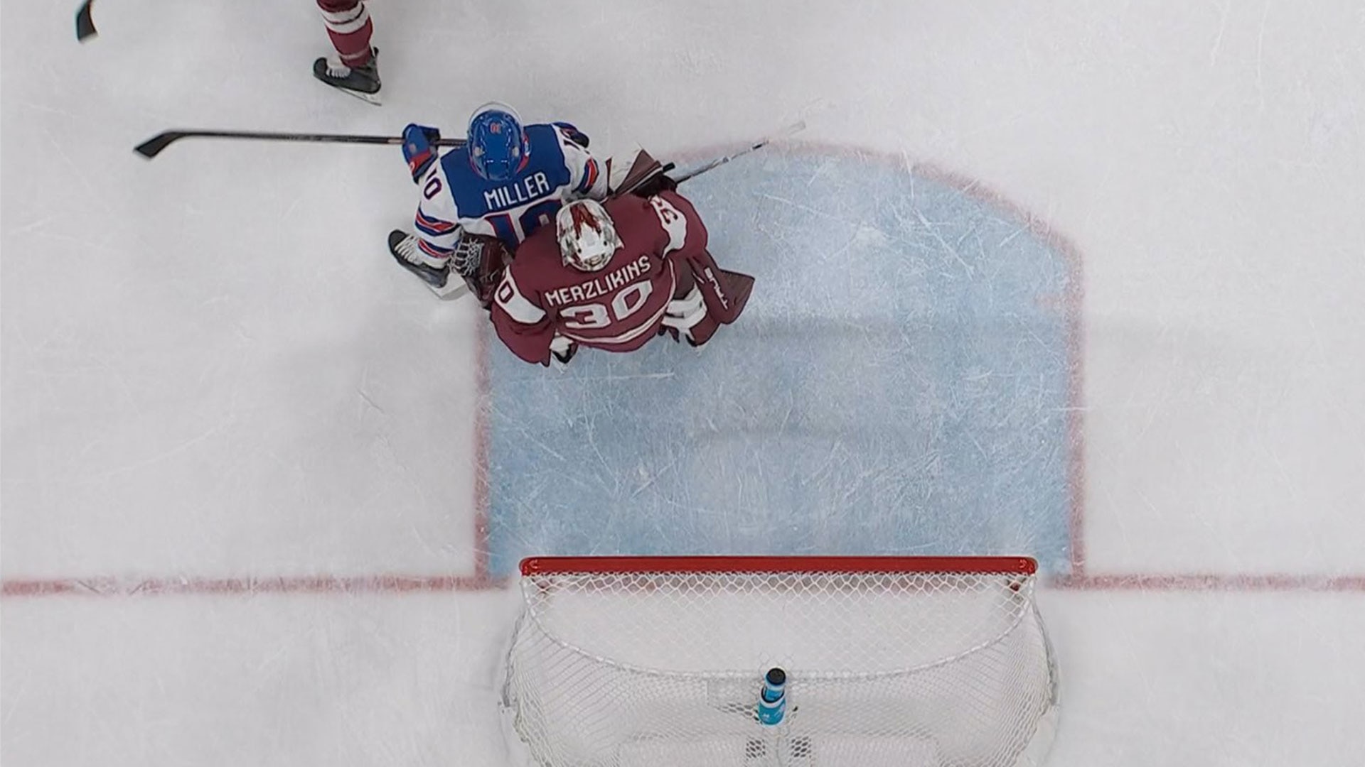 USA's J.T. Miller in front of Latvia goalie Elvis Merzlikins 