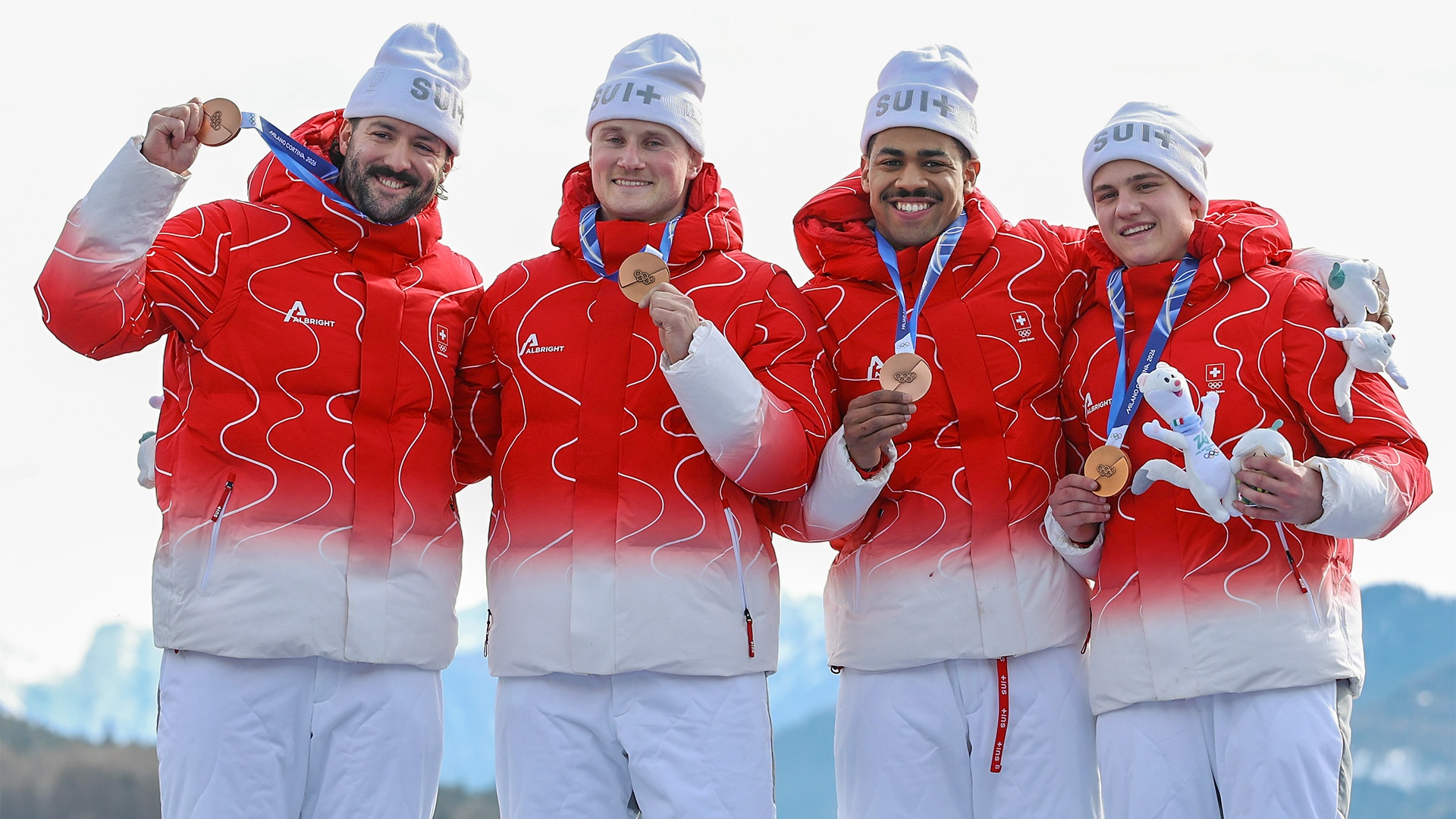 Switzerland four-man team poses with bronze medals