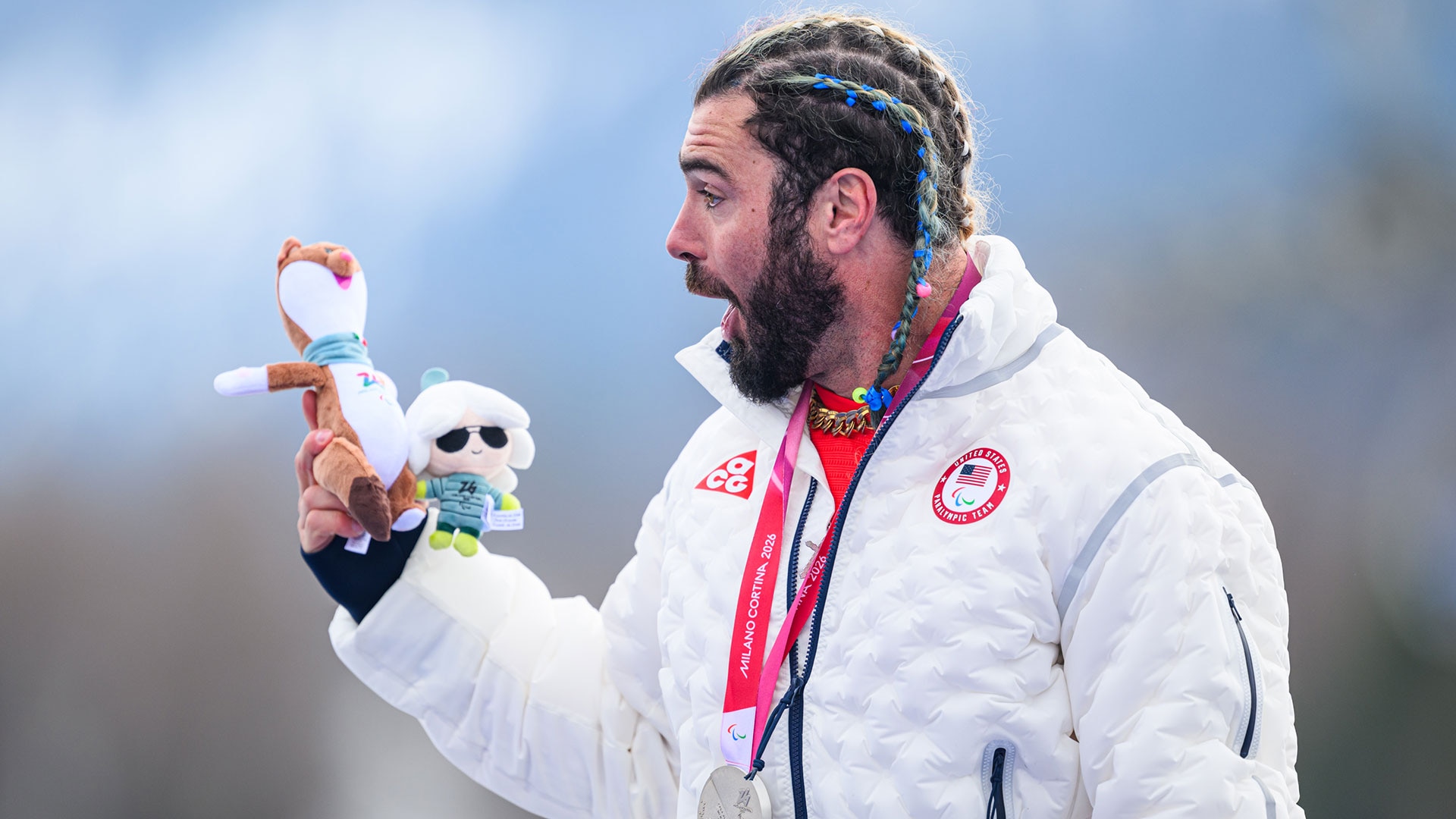 Patrick Halgren makes a silly face on the podium with his Paralympic mascot stuffed animal and silver medal