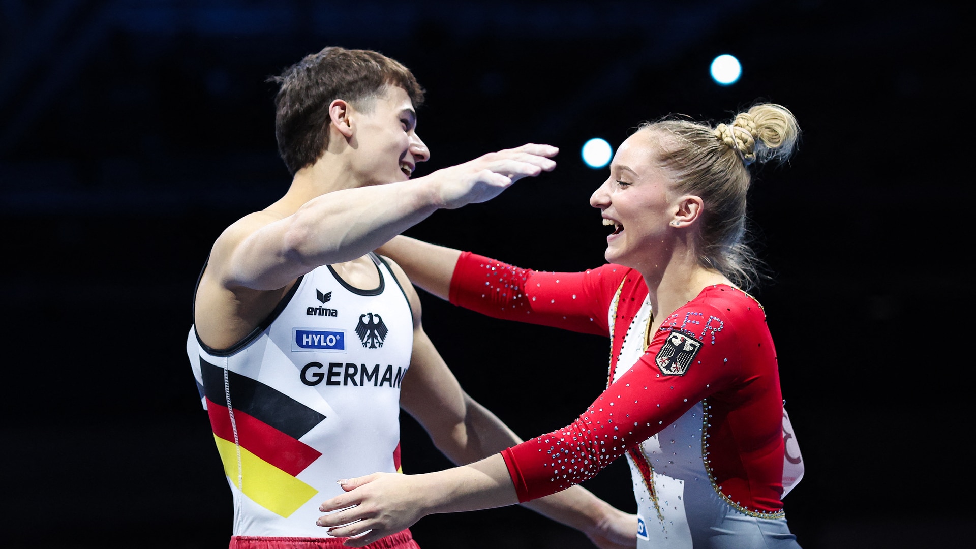 Gymnasts Timo Eder and Karina Schoenmaier hug