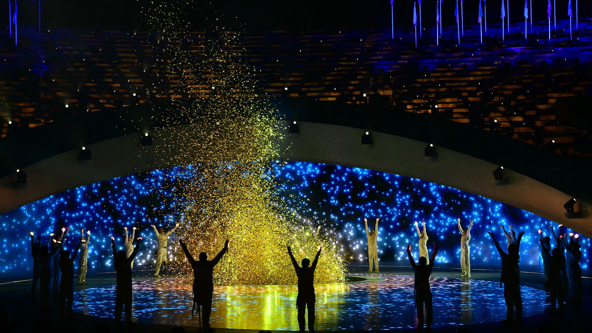 Performers dance around the newly-lit Paralympic cauldron during Opening Ceremony.