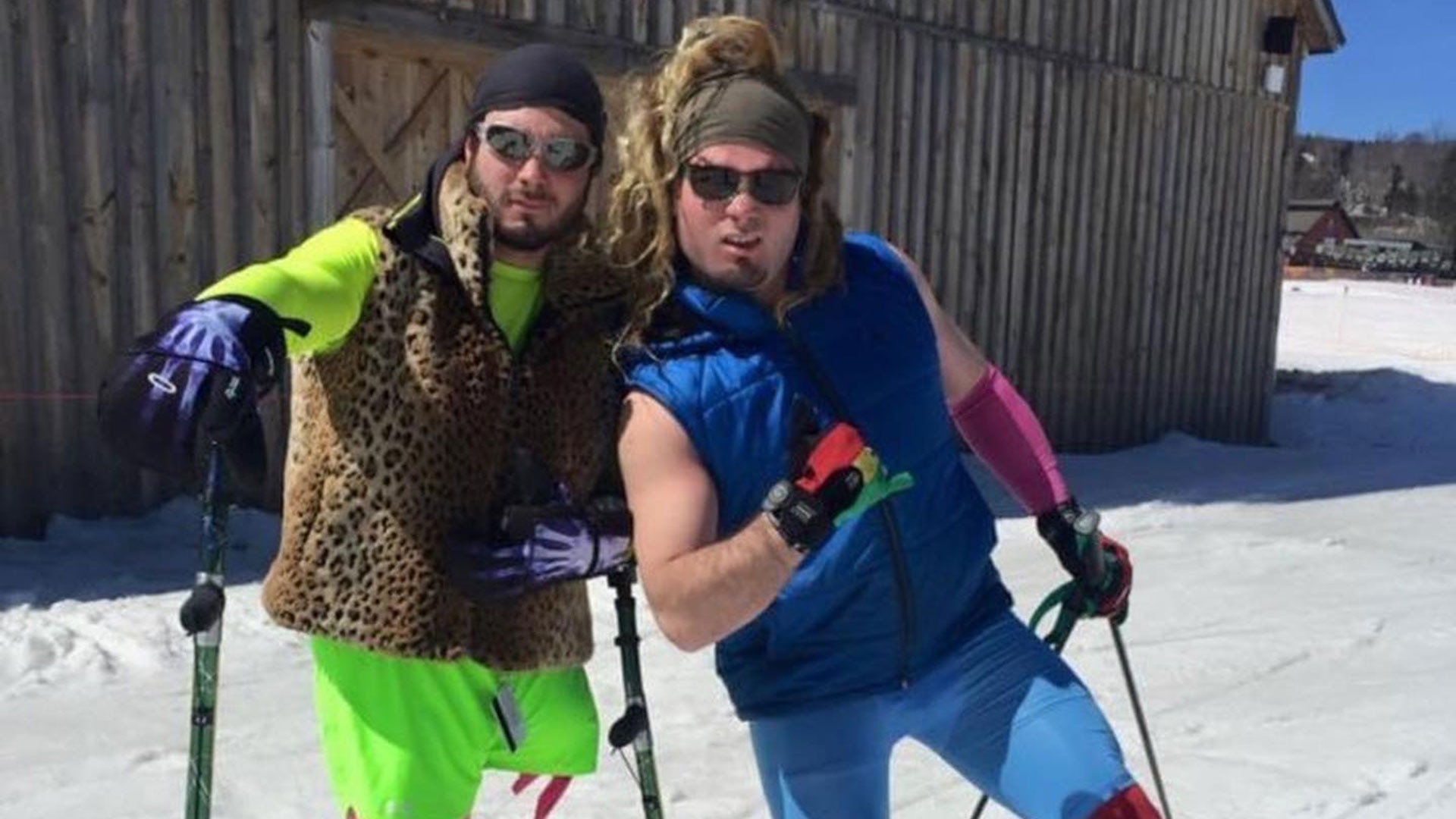 Patrick Halgren and his twin brother Sven pose for a photo in neon-colored and leopard print ski attire