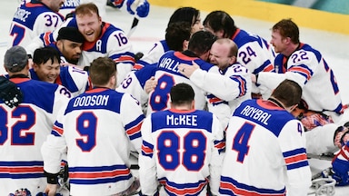 Members of the U.S. sled hockey team celebrate after winning gold at the 2026 Milan Cortina Paralympics.