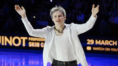 Ilia Malinin poses on the ice during a figure skating event.